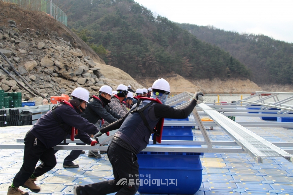 현장관계자들이 경남 합천댐에서 수상태양광 구조체를 조립하고 있다.
