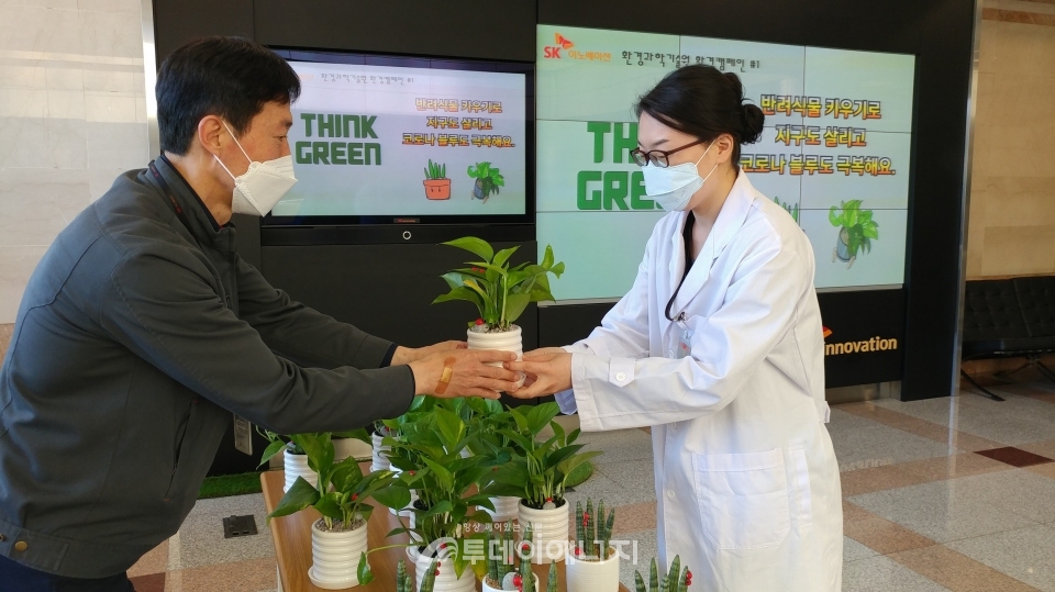SK이노베이션 환경과학기술원 구성원들이 '반려식물 키우기' 환경캠페인에 참여해 화분을 전달받고 있다.